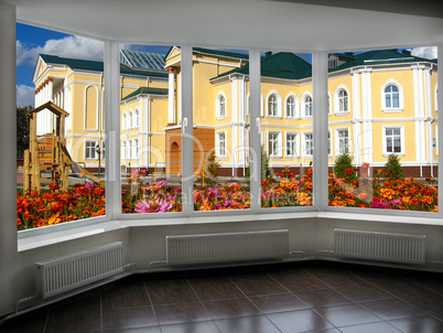 big window overlooking the garden with palace