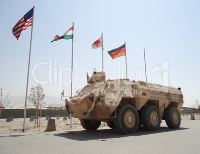 german armored ambulance vehicle  fuchs  in front of national flags