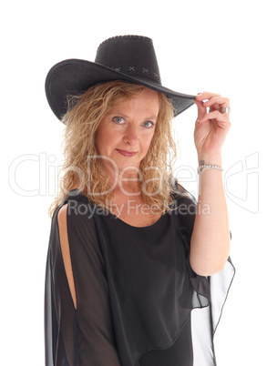 Woman in black dress and hat.