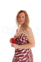 Blond woman with red coffee mug.