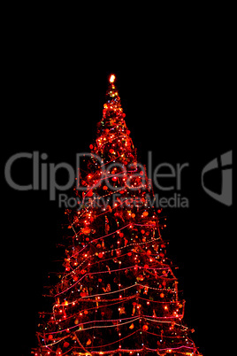 High Christmas tree shining at night