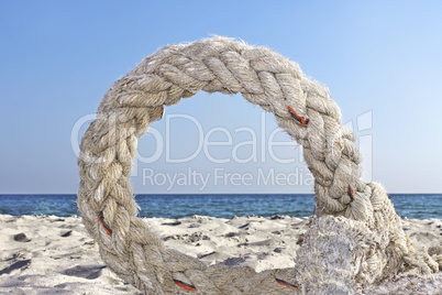 Ring of old rope on a seashore