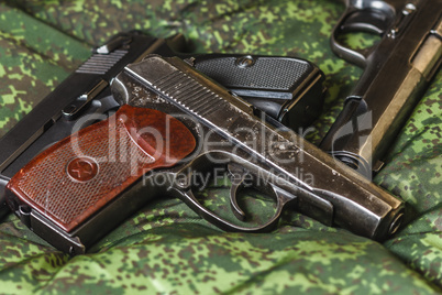 semi-automatic pistols on pixel camouflage background