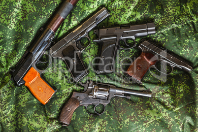 semi-automatic pistols on pixel camouflage background
