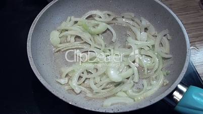 roasting onions in a pan