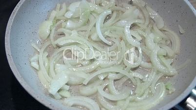 roasting onions in a pan