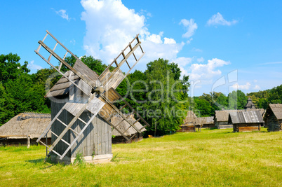 old wooden windmill in a field