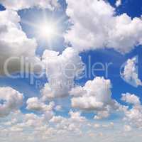 sun on blue sky with white clouds