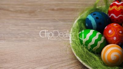 Easter Eggs in a Plate on a Light Wooden Background