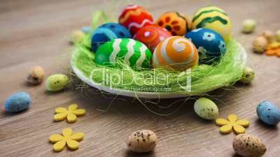 Easter Eggs Large and Small in the Bowl on Bright Wooden Background