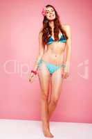 happy hippi model wearing bikini on pink