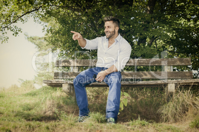 man outdoors pointing