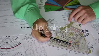 building, business, architecture, construction and people concept - close up of male hand with blueprint and pencil