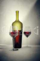 red wine bottle with two glasses