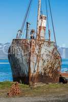 Close-up of old rusting whaler chained up