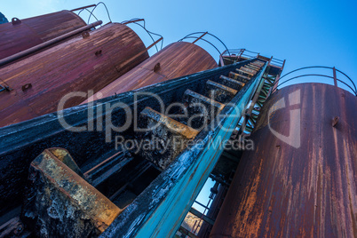 Rusty storage tanks with steps to top