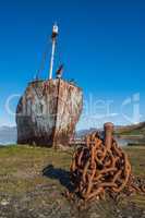 Rusty old whaler chained to iron post