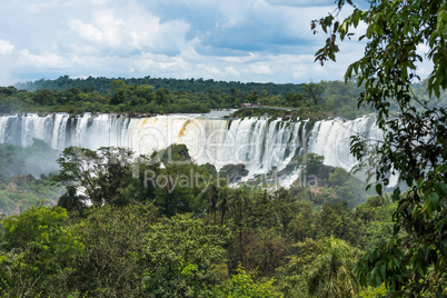Tourists on observation deck watching Iguazu Falls
