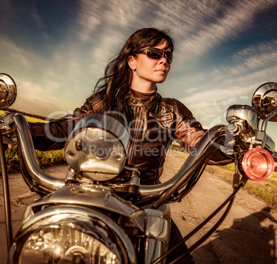 Biker girl sitting on motorcycle