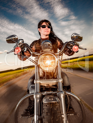 Biker girl sitting on motorcycle