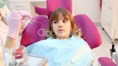 dentist check cavities in little girl