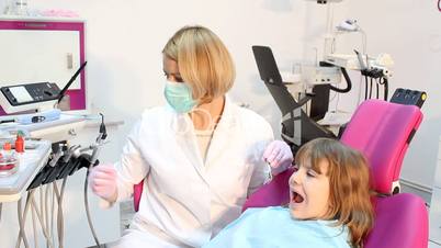 female dentist with borer and little girl