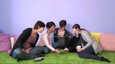 Group Of Pregnant Women Friends Moms Mothers Looking At Ipad