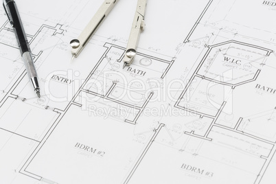 Engineer Pencil and Compass Resting on House Plans