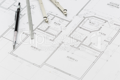 Engineer Pencil, Ruler and Compass Resting on House Plans