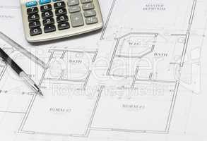 Pencil, Ruler and Calculator Resting on House Plans