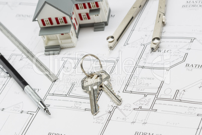 Home, Pencil, Ruler, Compass and Key Resting on House Plans