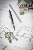 Home, Pencil, Ruler and Keys Resting On House Plans