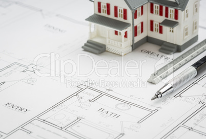 Model Home, Engineer Pencil and Ruler Resting On House Plans