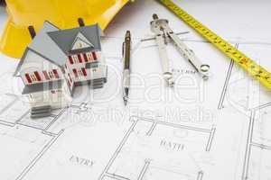 Home, Measuring Tape, Hard Hat, Pencil, Compass on House Plans