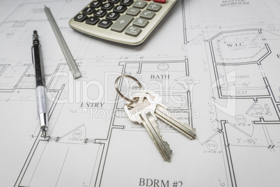 Pencil, Ruler, Calculator and Keys Resting on House Plans