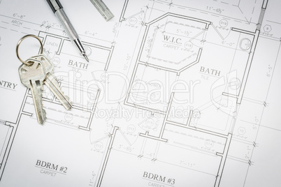 Engineer Pencil, Ruler and Keys Resting On House Plans