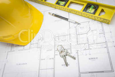 Hard Hat, Pencil, Level and Keys Resting on House Plans