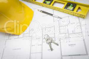 Hard Hat, Pencil, Level and Keys Resting on House Plans