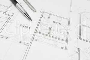 Engineer Pencil and Ruler Resting on House Plans
