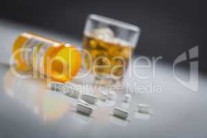 Prescription Drugs Spilled From Fallen Bottle Near Glass of Alco
