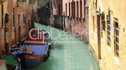 Canal with colorful boat in Venice