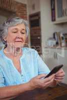 Senior woman text messaging on phone