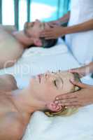 Woman receiving head massage from masseur