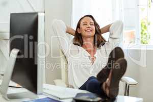 Happy businesswoman relaxing in office