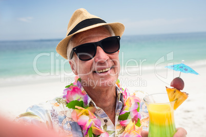 Happy senior man with a cocktail drink