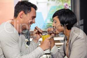 Cute couple drinking together orange juice