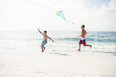 Father and son playing with kite