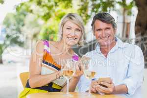 Portrait of happy couple using smartphone