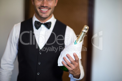 Handsome barman serving champagne