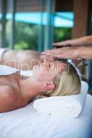 Woman receiving a massage from masseur